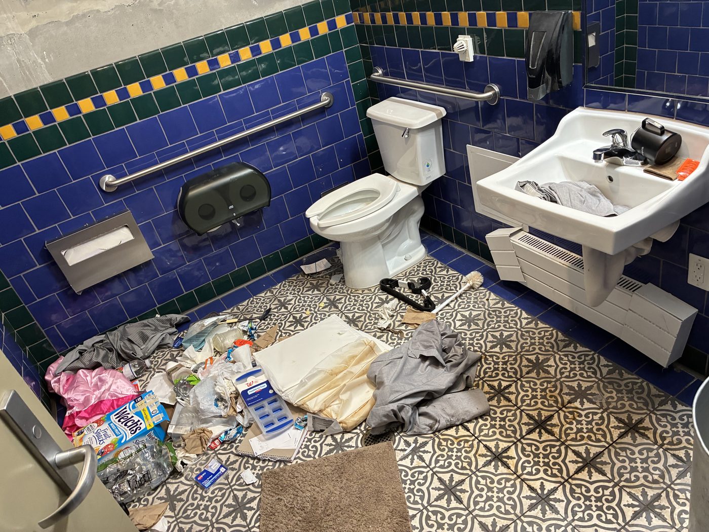 Trash room floor covered in debris before cleaning