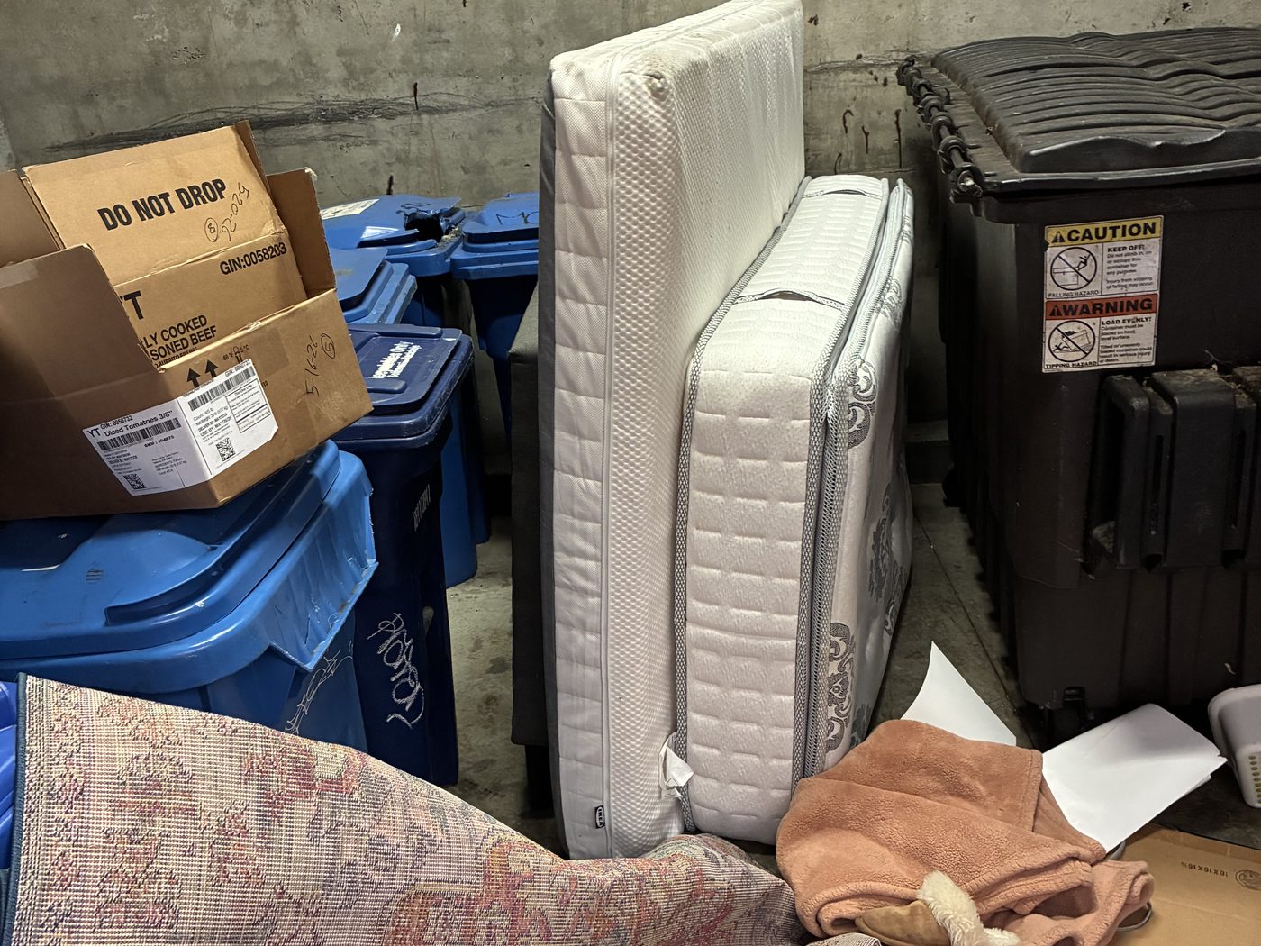 Shared trash area with mattress, boxes and bulk items