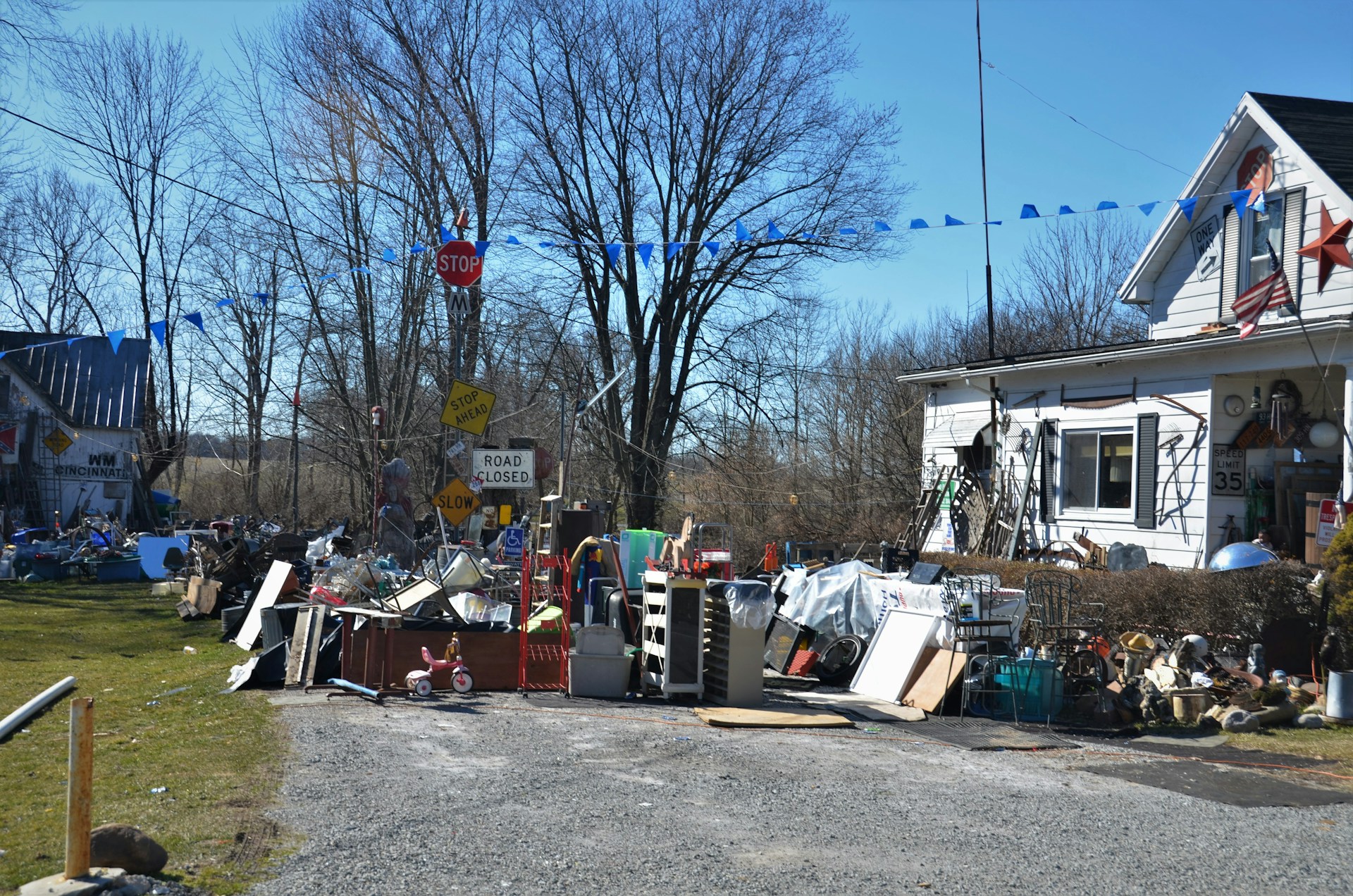Cluttered property yard filled with junk waiting to be hauled away