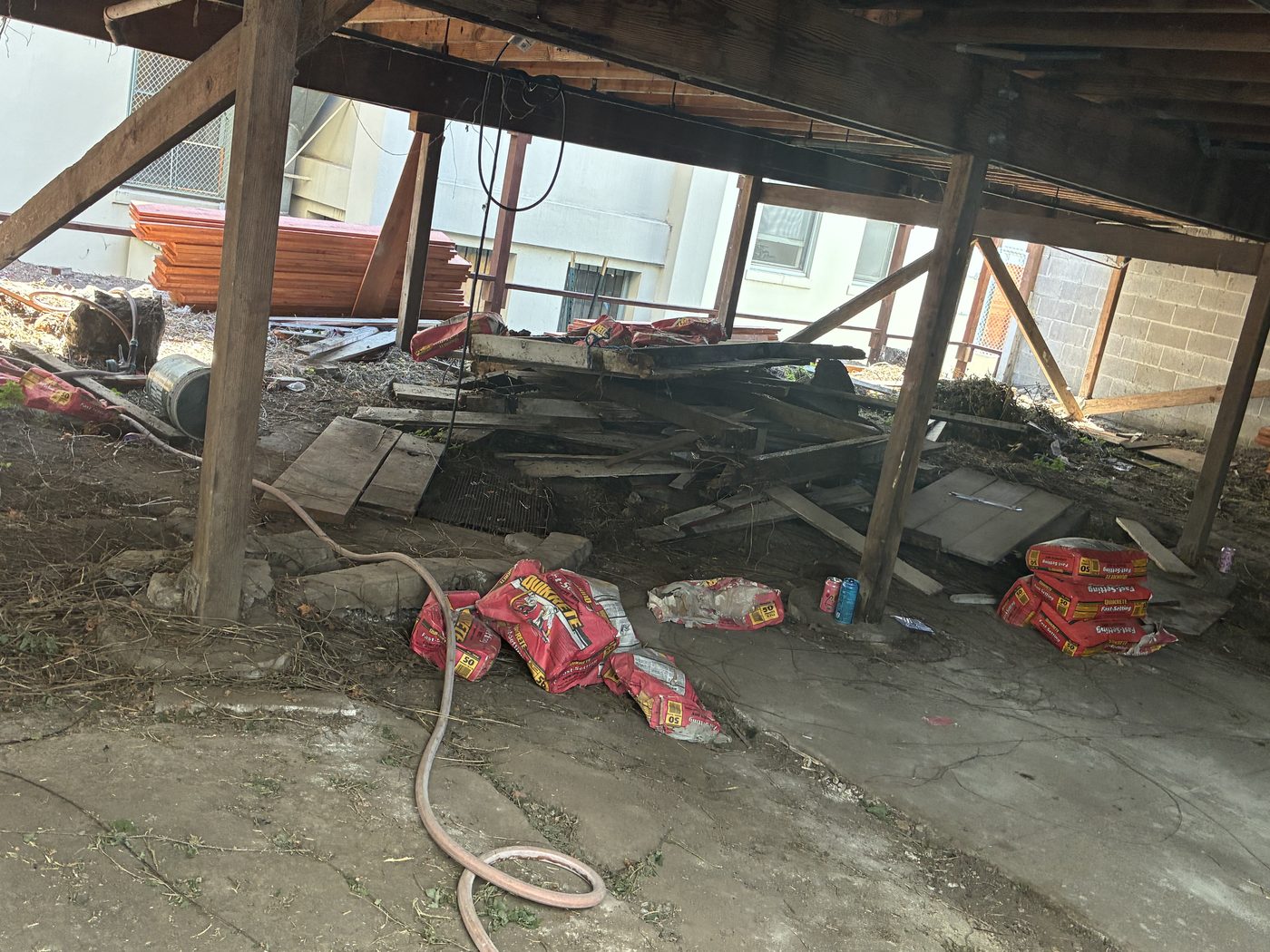 Under deck area filled with scrap wood and debris