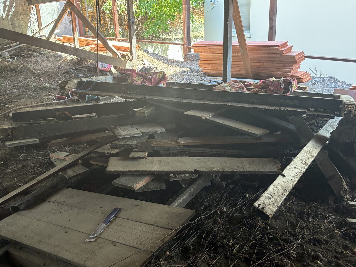 Backyard with broken decking and lumber debris