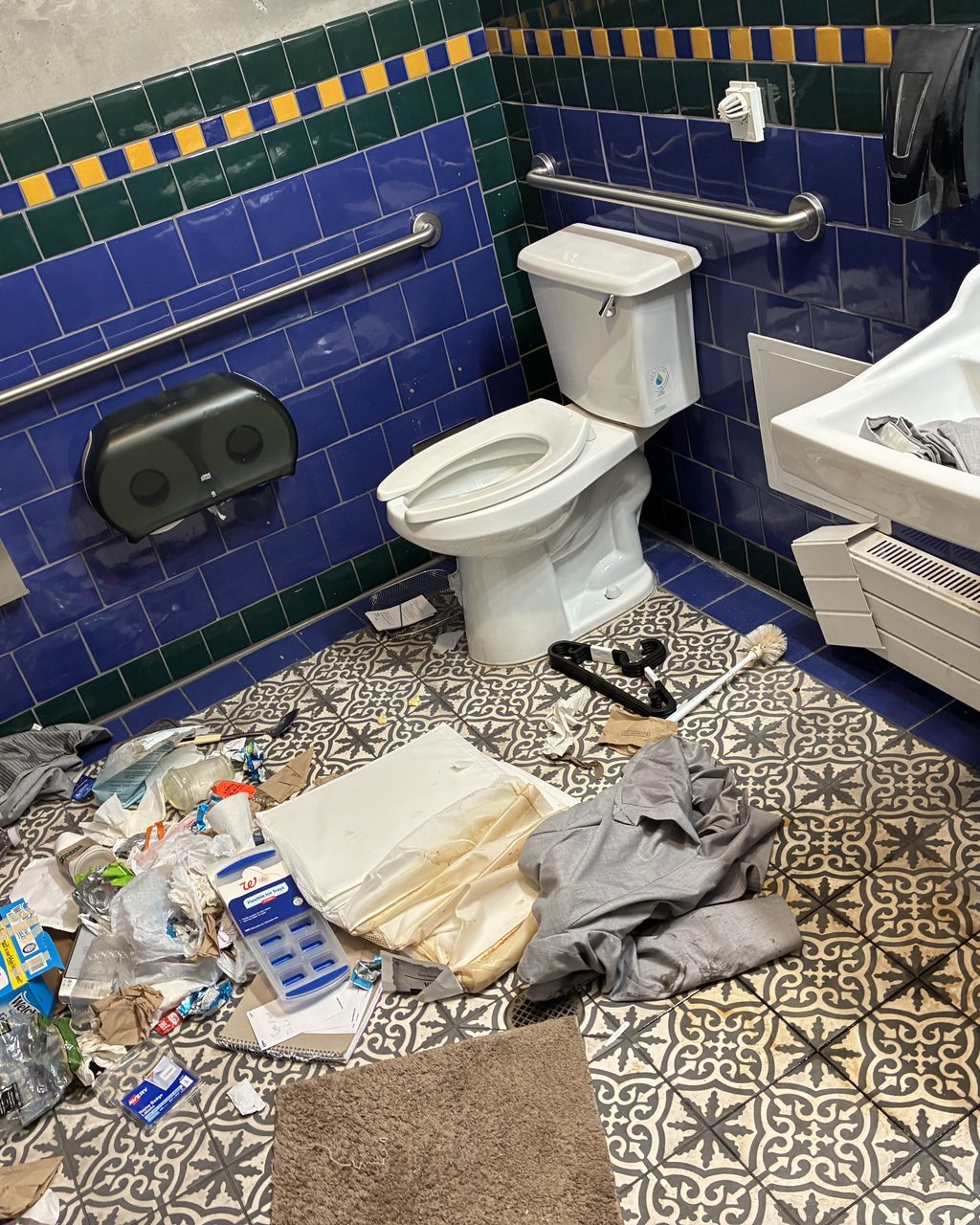 Trash room floor covered in debris before cleaning